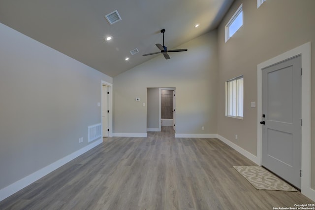 unfurnished living room featuring ceiling fan, high vaulted ceiling, and light hardwood / wood-style floors