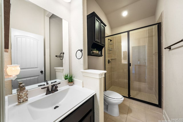 bathroom featuring vanity, toilet, a shower with shower door, and tile patterned flooring