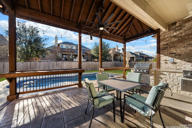 deck with a fenced in pool, a gazebo, area for grilling, and ceiling fan