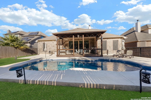 view of pool with ceiling fan and a patio area