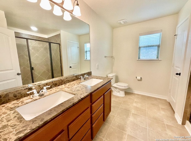 bathroom featuring a shower with door, vanity, a notable chandelier, and toilet