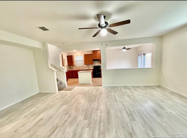 unfurnished living room featuring light hardwood / wood-style flooring and ceiling fan