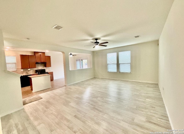 unfurnished living room with ceiling fan and light wood-type flooring