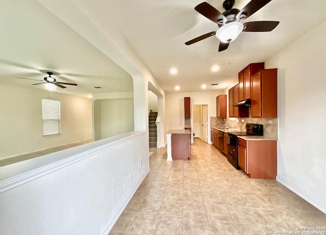 kitchen featuring sink, light tile patterned floors, a kitchen island, black range with electric stovetop, and backsplash