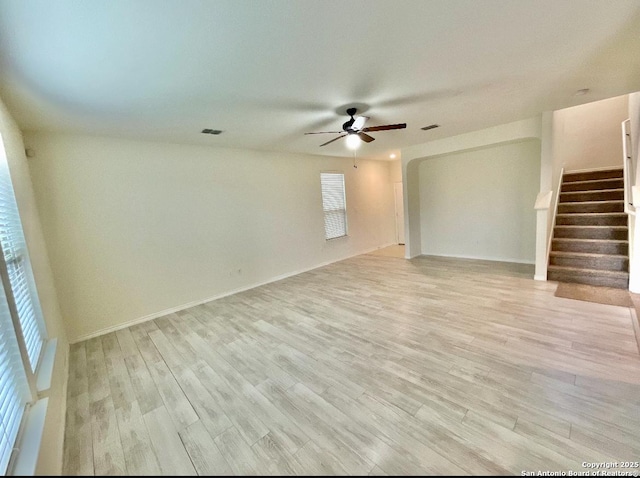 empty room featuring ceiling fan and light hardwood / wood-style flooring