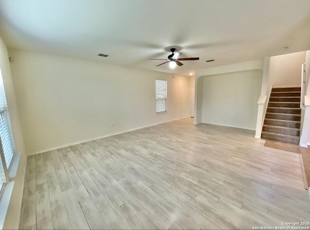 unfurnished room with ceiling fan and light hardwood / wood-style floors