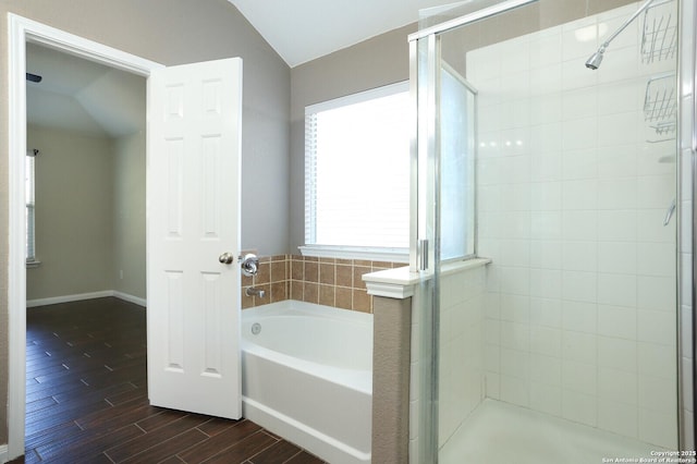 bathroom featuring baseboards, a stall shower, a garden tub, and wood tiled floor