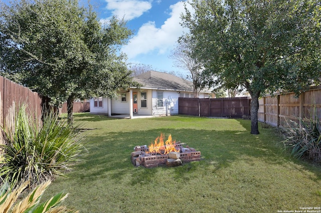 view of yard featuring an outdoor fire pit and a fenced backyard