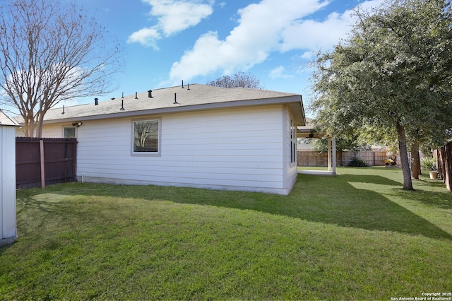 back of property with a yard and fence