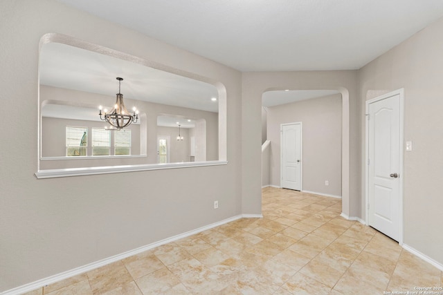 empty room featuring an inviting chandelier