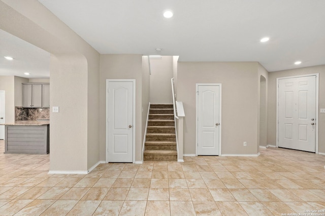 stairway with tile patterned floors