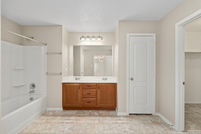 bathroom with shower / tub combination, vanity, and a textured ceiling