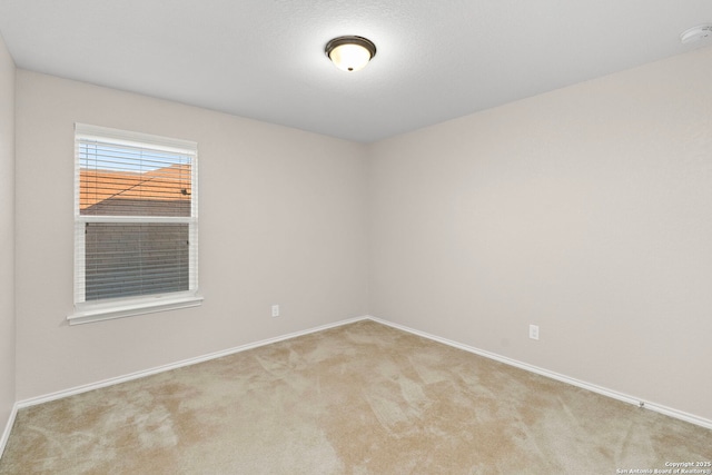 unfurnished room featuring light colored carpet