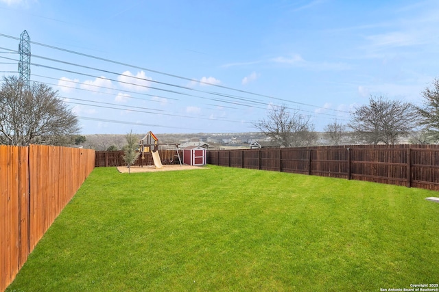 view of yard featuring a shed and a playground