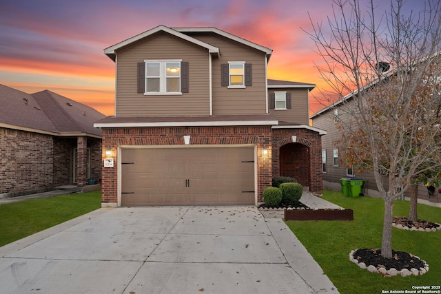 view of property featuring a yard and a garage