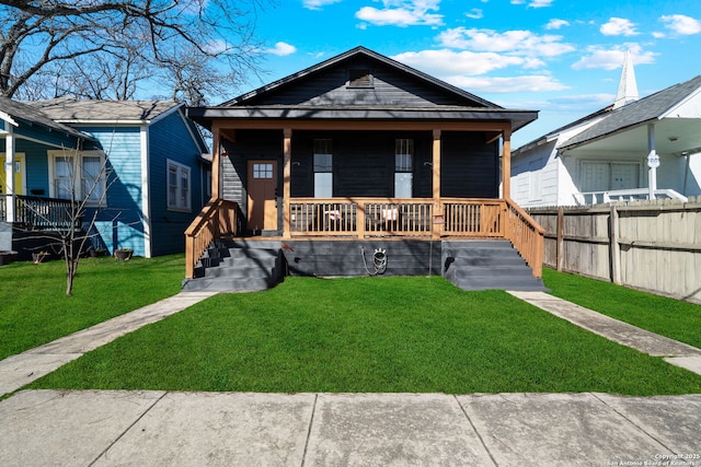 bungalow featuring a porch and a front lawn