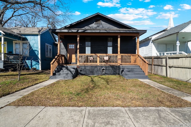 bungalow featuring a front yard and covered porch