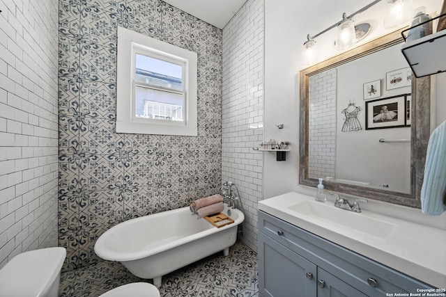 bathroom with vanity, a washtub, tile walls, and toilet