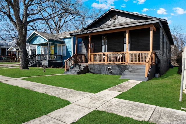 bungalow-style house featuring a front yard and covered porch