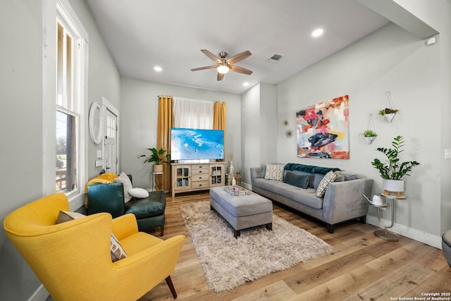 living room with hardwood / wood-style floors and ceiling fan