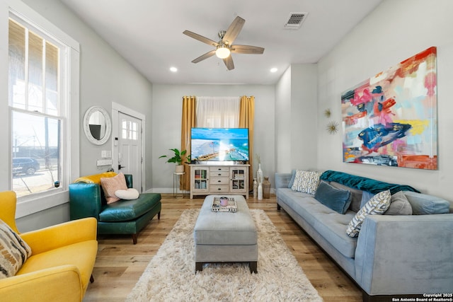 living room featuring ceiling fan and light hardwood / wood-style floors