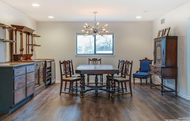 dining room featuring dark hardwood / wood-style flooring, ornamental molding, and a chandelier