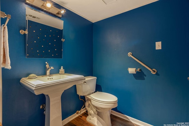 bathroom with wood-type flooring and toilet