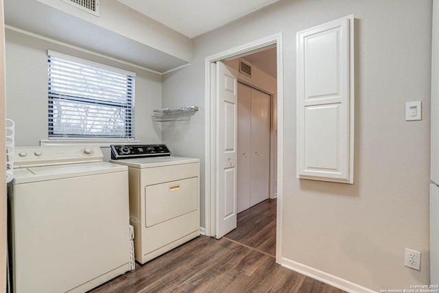 laundry room with washer and dryer and dark hardwood / wood-style floors