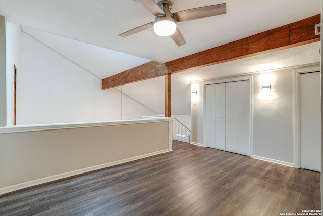 additional living space with dark hardwood / wood-style floors, vaulted ceiling with beams, and ceiling fan