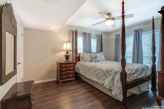 bedroom with ceiling fan, a textured ceiling, and dark hardwood / wood-style flooring