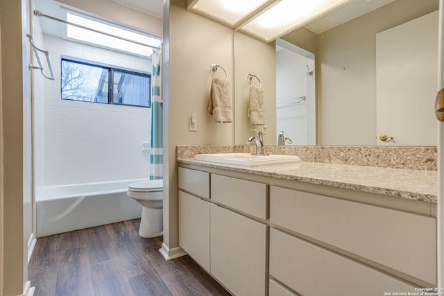 full bathroom featuring shower / tub combo with curtain, wood-type flooring, toilet, and vanity