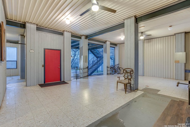 interior space with ceiling fan