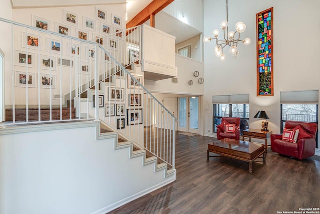 stairs featuring hardwood / wood-style floors, a chandelier, and a high ceiling
