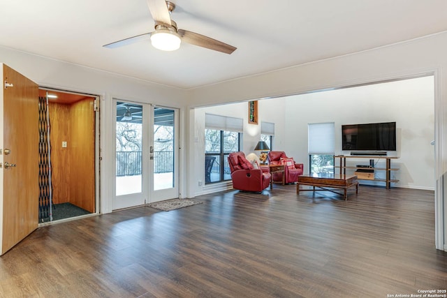 living room featuring dark wood-type flooring, ceiling fan, and french doors