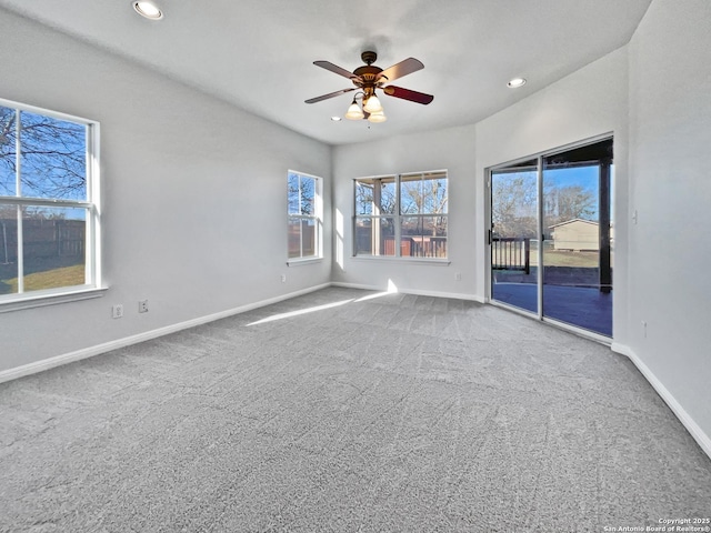 spare room with ceiling fan and carpet