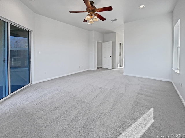 carpeted spare room with ceiling fan