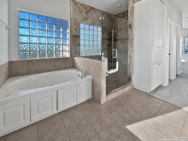 bathroom featuring tile patterned floors and plus walk in shower