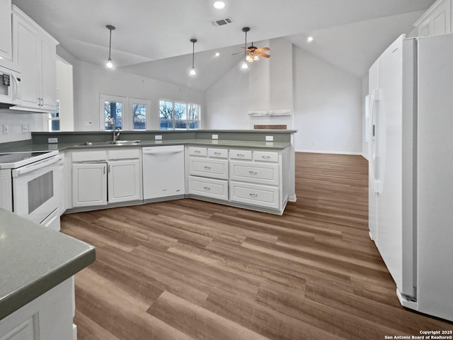 kitchen featuring sink, white cabinets, white appliances, and kitchen peninsula