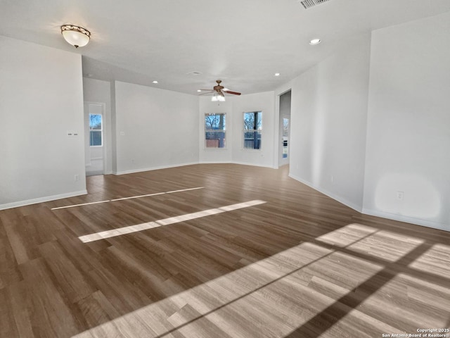 empty room with hardwood / wood-style flooring and ceiling fan