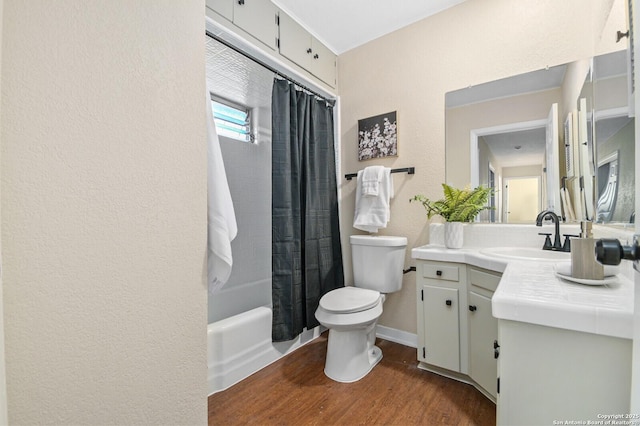 full bathroom featuring vanity, hardwood / wood-style flooring, shower / bath combination with curtain, and toilet