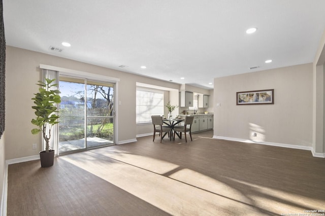 dining space with dark hardwood / wood-style flooring