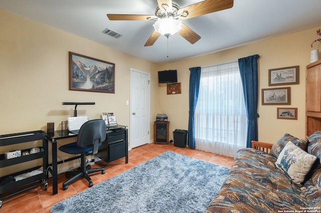 office area with light tile patterned floors and ceiling fan