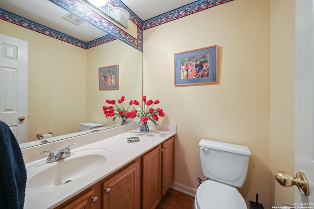 bathroom featuring vanity, tile patterned flooring, and toilet