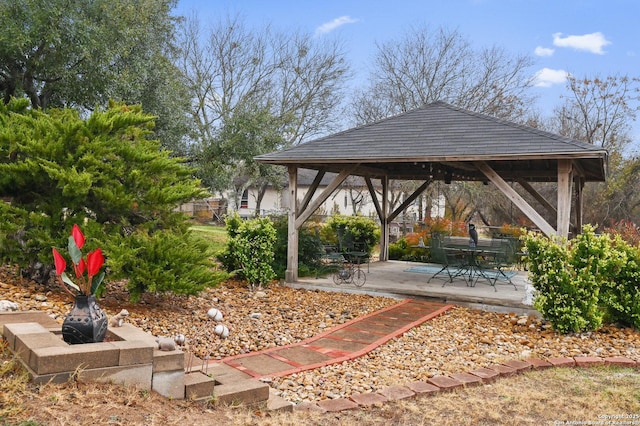 view of property's community featuring a patio, a gazebo, and an outdoor fire pit