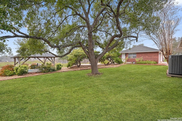 view of yard with a gazebo and central AC unit