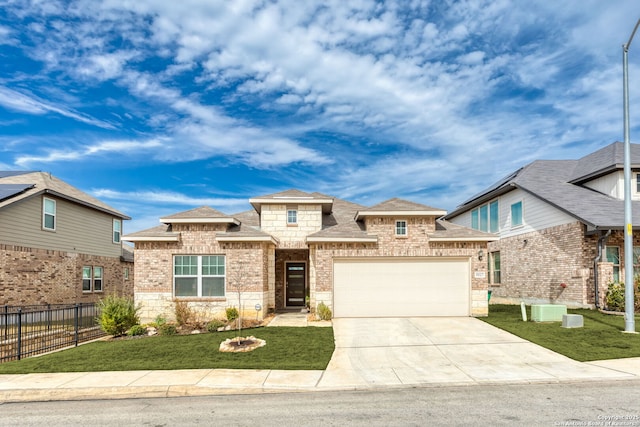 view of front of property featuring a garage, central AC, and a front yard