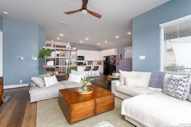 living room with ceiling fan, wood-type flooring, and vaulted ceiling