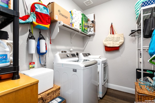 washroom with dark hardwood / wood-style flooring and independent washer and dryer