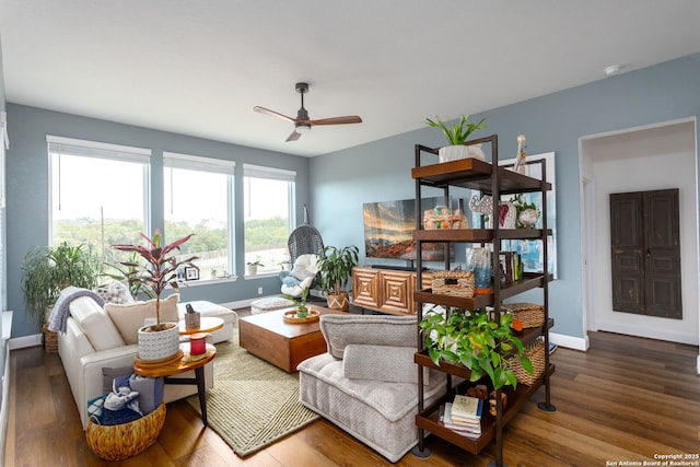 living room featuring hardwood / wood-style floors and ceiling fan