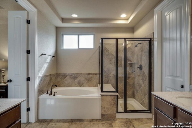 bathroom featuring vanity and separate shower and tub